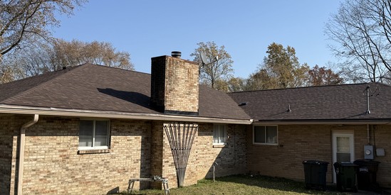 Brick ranch home with a completed architectural shingle roof replacement